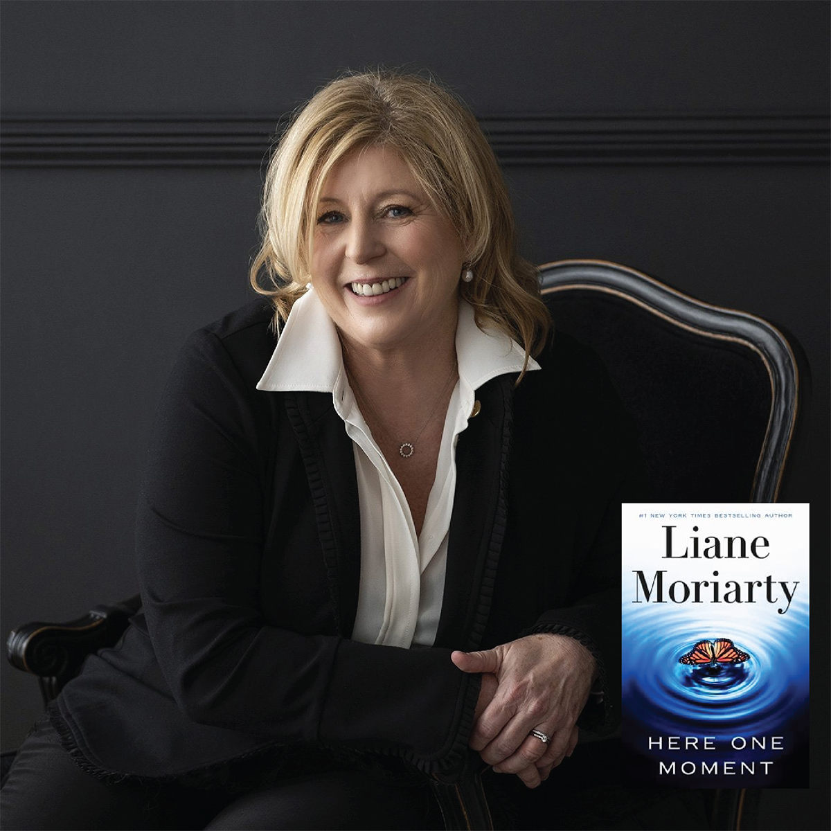 Author Liane Moriarty poses with her latest book, 'Here One Moment,' in a studio setting.