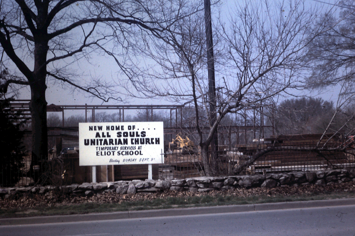 Sign reading 'New Home of All Souls Unitarian Church' during the 1957 construction, with temporary services at Eliot School.