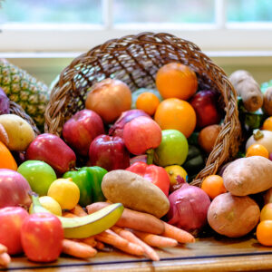 A colorful basket of fruits and vegetables in a cornucopia on the chancel at All Souls Unitarian Church.