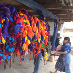 Brightly colored bundles of yarn displayed in a Guatemalan market stall.