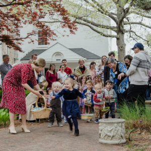 Children eagerly running during the Easter egg hunt on the front lawn of All Souls Unitarian Church.