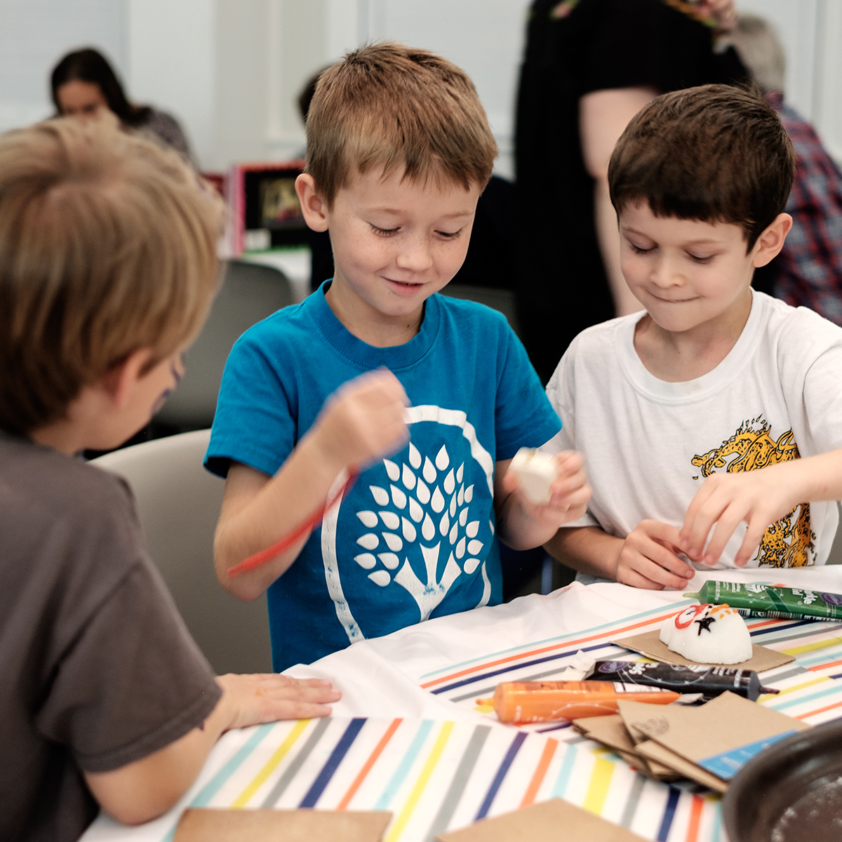 Children focus on decorating sugar skulls during a creative activity at All Souls Unitarian Church.