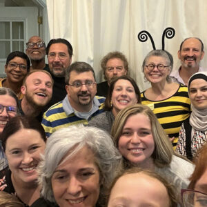 All Souls Unitarian Church staff and volunteers gather for a fun group photo, with one person dressed in a bee costume.