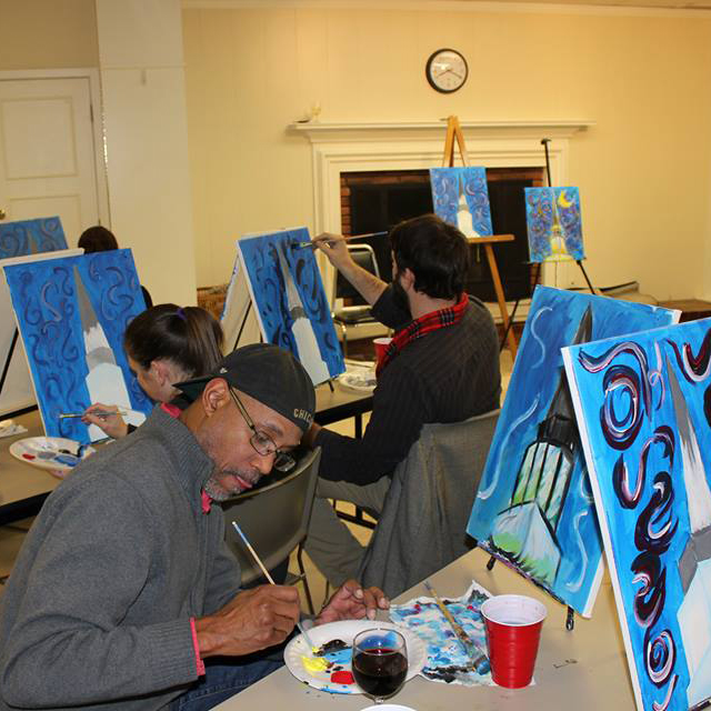 Participants paint on canvas at All Souls Unitarian Church painting the building steeple.