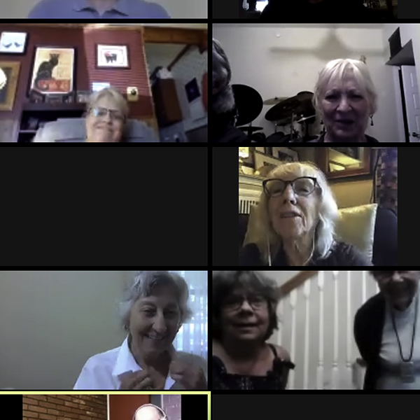 Participants in a Zoom meeting smile and interact from various locations, engaging in virtual community at All Souls Unitarian Church.