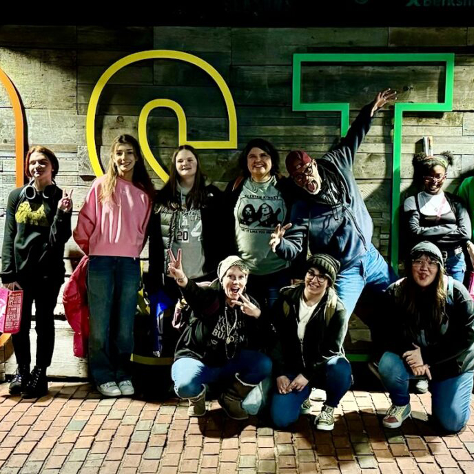 The All Souls 2024 Coming of Age class standing in front of a sign that reads BOSTON in large, colorful letters.