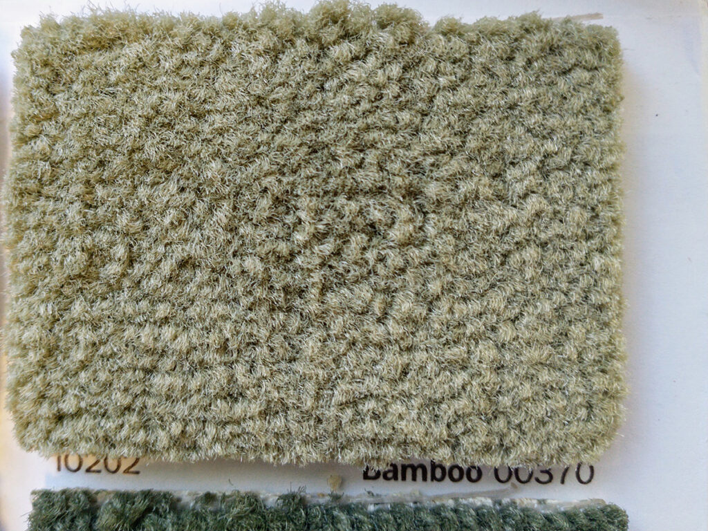 A closeup of a carpet sample in a pale neutral green color, labeled "Bamboo"