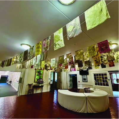 A collection of Prayer Flags made from natural materials, hanging in the foyer of a church.